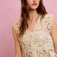 Natural crochet sleeveless vest top with V-neck and detailed circular floral motifs