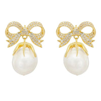 Gold drop earrings with jeweled ribbon bows and white pearl dangle