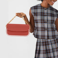 Red leather shoulder bag with gold chain handle and front flap