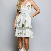 Natural palm tree print wrap dress with smocked waist and tiered ruffle hem, sleeveless