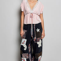 Blush striped V-neck lace peplum blouse with tie waist and ruffled short sleeves