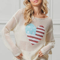 Off-white sequin knit sweater with American flag heart design, long sleeves.