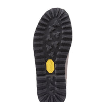 Black lugged boot outsole with a yellow Vibram label