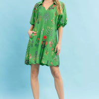 Green floral mini dress with V-neck and short puff sleeves, full front view