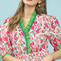 Floral ruffle-trim dress close-up: pink mix with green V-neck and puff sleeves