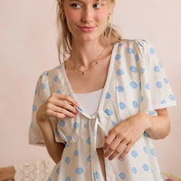 Ivory dot-print tie-front blouse with flutter sleeves and V-neck front tie.