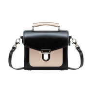 Black leather crossbody handbag with beige front flap and silver front buckle