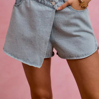 Light blue washed denim wrap skort with button closure and side pockets