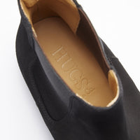 Close-up of black suede Chelsea boot opening with tan Hugs insole