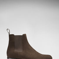 Brown suede Chelsea boot in side profile with a low heel