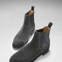 Pair of gray suede Chelsea boots shown from an angled front view