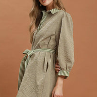 Olive belted striped mini dress with puff sleeves and green-and-white striped hem