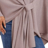 Women’s shawl cape detail: front tie knot with pleated drape over denim