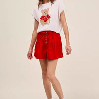 Red denim shorts with elastic waistband, front buttons, and waist tie.
