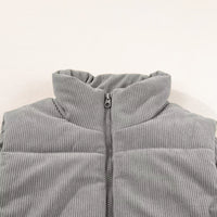 Gray corduroy stand-neck puffer vest close-up with front zipper and ribbed collar.