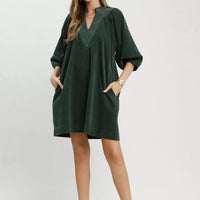 Hunter green corduroy V-neck shift dress with puff sleeves and relaxed skirt
