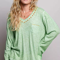 Light green V-neck knit top with embroidered neckline trim and front pocket