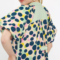 Polka dot tunic dress close-up back with ruffled trim and striped V-neck facing