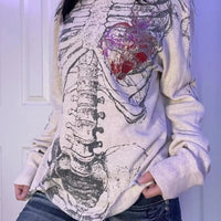 White long sleeve t-shirt with skeleton and heart graphic on front