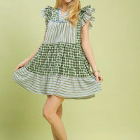 Green patchwork tiered mini dress with ruffled flutter sleeves and flared striped-and-dot skirt.