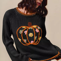 Black knit sweater with embroidered pumpkin and floral patchwork front