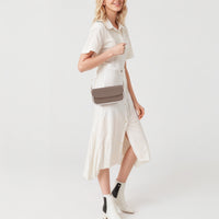 Brown leather small shoulder bag with flap closure and gold chain crossbody strap