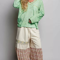 Light green V-neck knit long sleeve top with contrast trim and chest pocket