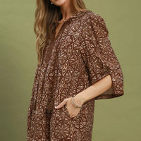 Brown geometric print tunic dress with V-neck and tassel tie, flared sleeves