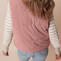 Dusty pink corduroy stand-neck zipped puffer vest, back view with quilted panels.