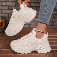 White chunky platform sneakers, lace-up mesh with thick platform sole and textured tread.