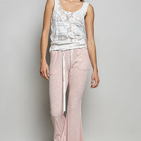 Blush pink textured knit pants with drawstring waist and flared straight legs