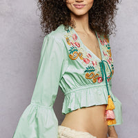 Mint floral embroidered cropped blouse with V-neck, wide bell sleeves, tassels