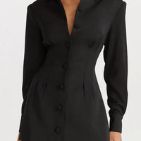 Black blazer-style mini dress with notched collar and long sleeves, featuring button details.
