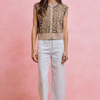 White mid-rise wide-leg jeans with ruffled hem and front pockets