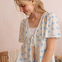 Light ivory shell-print blouse with tie-front and short flutter sleeves
