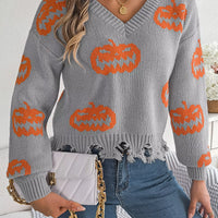Gray knit V-neck sweater with orange pumpkin pattern and distressed fringe hem