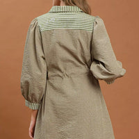 Olive belted striped mini dress shown from back, with striped cuffs and hem