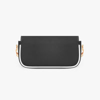 Black mini shoulder bag with curved white trim, flap front and gold strap hardware