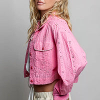 Candy pink eyelet-textured cropped jacket with button front, long sleeves, flap pockets