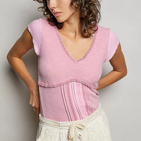 Soft pink textured knit top with lace-trim V-neck and short sleeves, side view