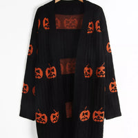 Black open-front knit cardigan with orange pumpkin jack-o'-lantern motif print, long sleeves