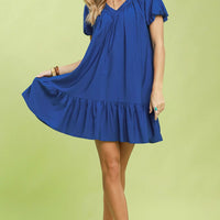 Blue V-neck shift mini dress with tiered ruffle hem and puff sleeves, full body.