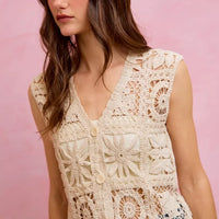 Natural crochet sleeveless vest top with V-neck, button front, and openwork floral motifs