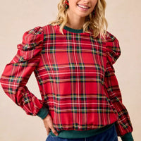 Red plaid top with exaggerated shoulders, balloon sleeves, and green ribbed waistband