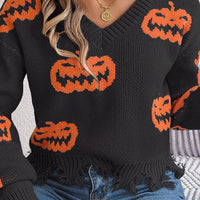 Black V-neck sweater with orange pumpkin knit pattern and distressed, frayed hem