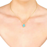 Gold-tone Hamsa opalite blue pendant necklace on neckline