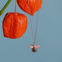 Rose gold honey bee pendant necklace pendant hanging from a thin chain