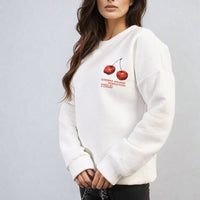 White oversized knitted jumper with small cherry front graphic and long sleeves