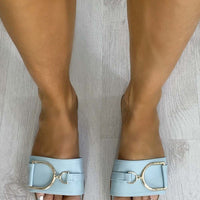 Blue wide-strap slide sandals with gold tone ring detail, open toe