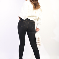Black high-waisted skinny jeggings with knee rips and faded distressed details